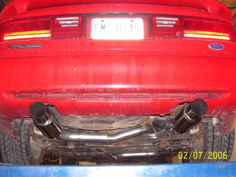 1994 Ford Probe - The rear of a red 1994 Ford Probe is shown, highlighting its dual exhaust system and license plate.