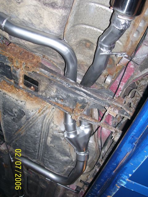 1994 Ford Probe - Custom exhaust system installation visible on the underside of a vehicle.