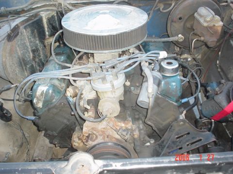 1979 Ford Bronco - The engine bay of a 1979 Ford Bronco, showing the V8 engine components and surrounding hardware.