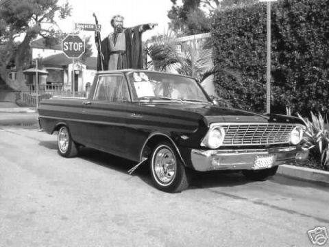 1979 Ford Ranchero - A black 1960 Ford Falcon Ranchero pickup truck is parked on a street with a man dressed as Moses standing on its roof.