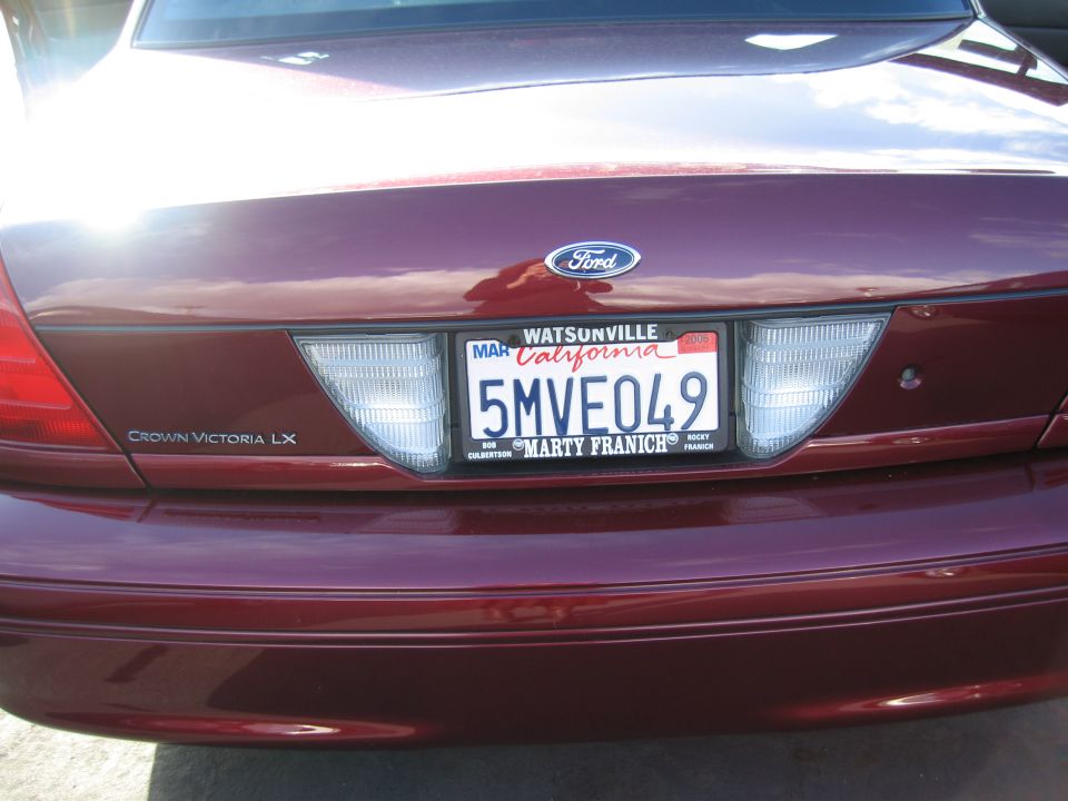 Maroon 2005 Ford Crown Victoria LX rear view with California license plate 5MVE049