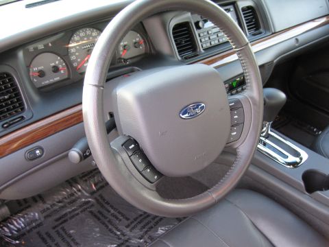 2005 Ford Crown Victoria - The interior of a 2005 Ford Crown Victoria, the steering wheel, instrument cluster, and center console.