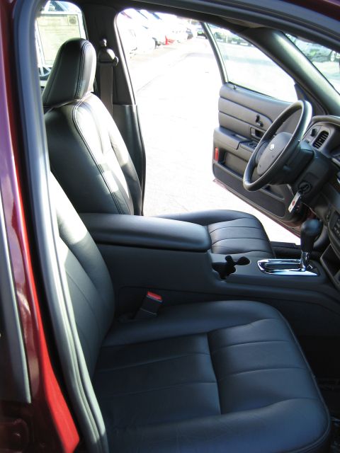 2005 Ford Crown Victoria - Interior view of a 2005 Ford Crown Victoria, highlighting the front seating area and dashboard.