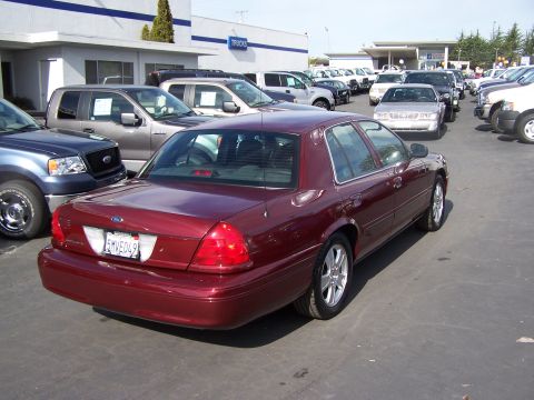2005 Ford Crown Victoria - Rear view of a maroon 2005 Ford Crown Victoria at a car lot.