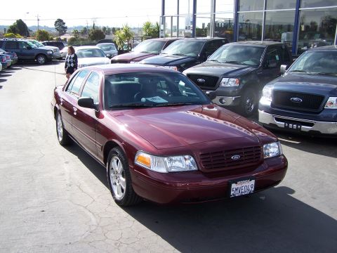 2005 Ford Crown Victoria - Maroon 2005 Ford Crown Victoria parked in a lot with other vehicles.