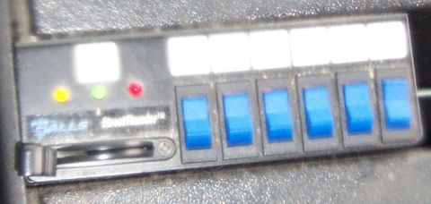 1998 Ford Crown Victoria - A close-up view of a control panel with multiple switches and indicator lights.