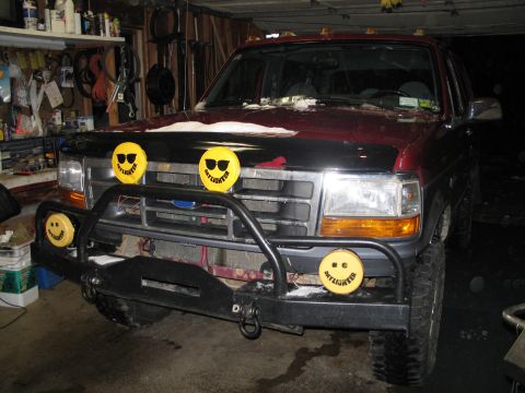 1995 Ford Bronco - 1995 Ford Bronco parked in a garage, equipped with KC lights and a brush guard.