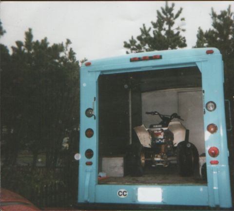 1995 Ford Mustang - A Yamaha ATV is parked inside the cargo area of a light blue truck.