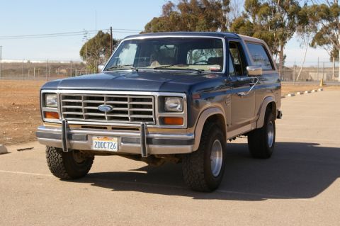 1986 Ford Bronco - This Ford Bronco features a prominent grille and dual-tone paint accents.