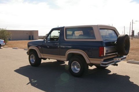 1986 Ford Bronco - Rear three-quarter view of a 1986 Ford Bronco parked in a lot.
