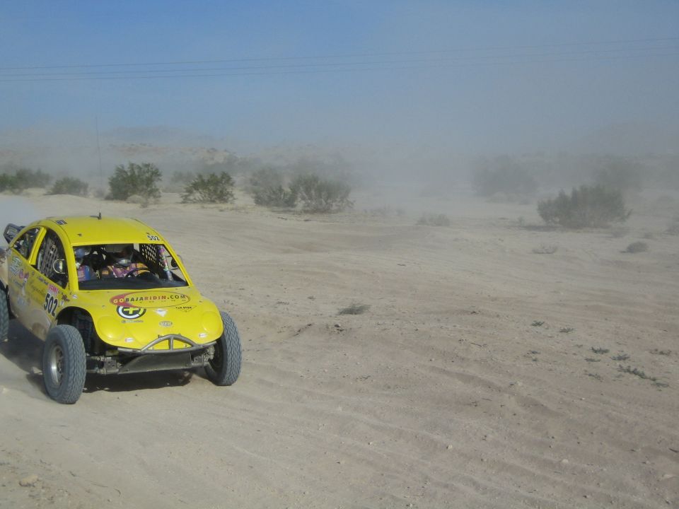 Yellow Baja-bug style race car number 503 racing across the desert