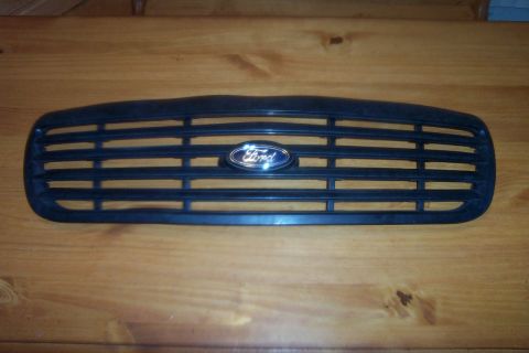 1998 Ford Crown Victoria - A black Ford grille with horizontal slats and a blue oval Ford emblem is shown.