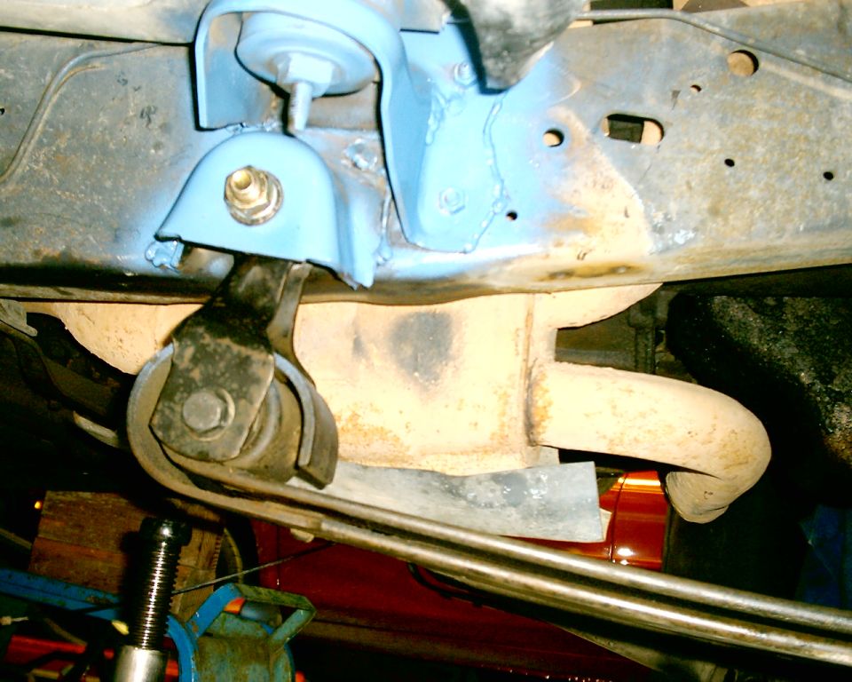 Exhaust pipe and blue suspension parts under a vehicle
