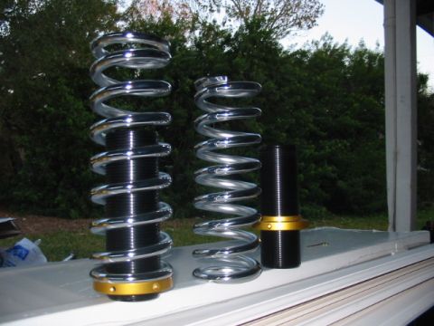 1985 Ford Crown Victoria LTD - Aftermarket coilover suspension components are displayed, chrome springs and adjustable black bodies with gold accents.