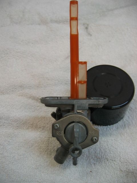 1985 Ford LTD Crown Victoria - This is a close-up of a motorcycle fuel petcock, showing the fuel filter and selector knob.