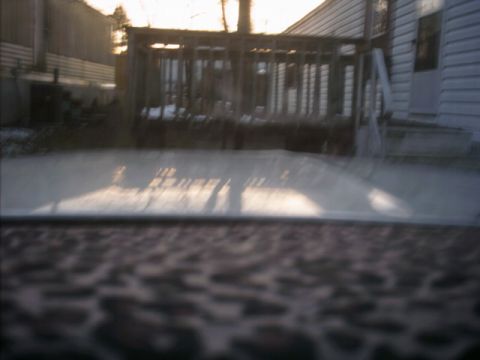 1985 Ford Crown Victoria LTD - The reflection on the car hood shows a deck and house, not the vehicle itself.
