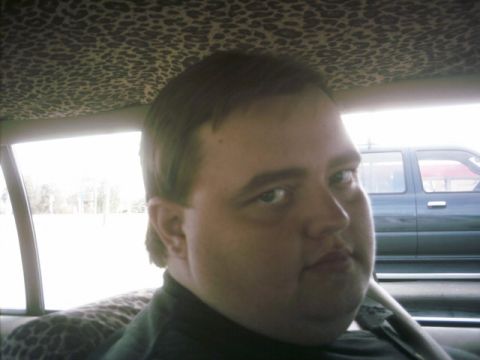 1985 Ford Crown Victoria LTD - A man is seen inside a car with a leopard print headliner, while another vehicle is visible through the window.