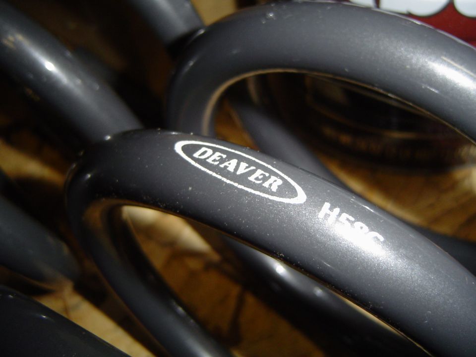Close-up of black Deaver coil spring with H586 part marking stamped on the coil