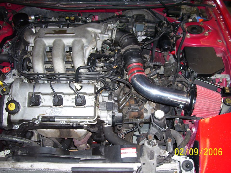 Ford Probe V6 engine bay with polished cold air intake pipe and red cone air filter