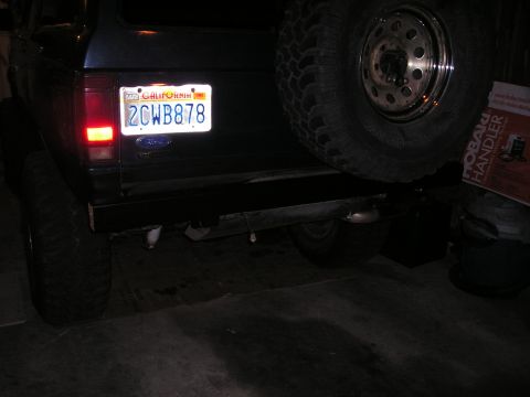 1986 Ford Bronco II - The rear of a dark SUV is shown, a California license plate and a spare tire mounted externally.