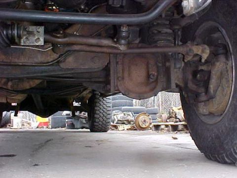 2000 Ford E350 - The underside of a vehicle is captured, revealing its mechanical components and suspension system.