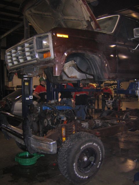 1978 Ford Bronco - 1978 Ford Bronco undergoing service with front clip and engine accessible.