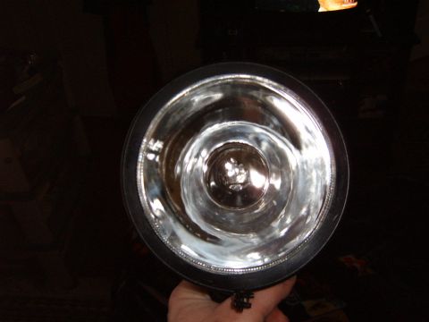 1993 Ford Bronco - The reflective interior of a vehicle headlight is shown in this close-up shot.