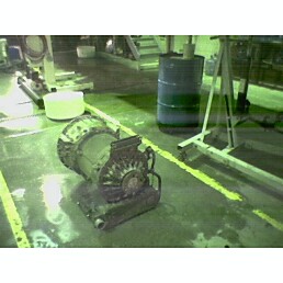 1979 Ford Bronco - A heavy-duty engine or generator unit sits on a floor marked with yellow lines.