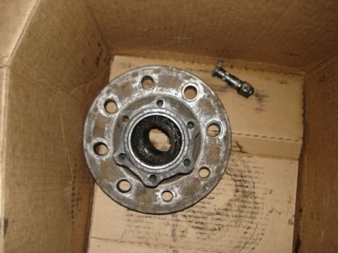 1978 Ford F-250 - A wheel hub and a lug nut are shown in a cardboard box.