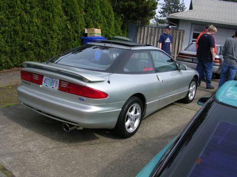 1996 Ford Probe - A silver 1996 Ford Probe is seen from a three-quarter front angle, parked next to other vehicles.