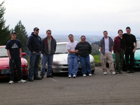 1996 Ford Probe - A group poses with their 1996 Ford Probe and other vehicles.