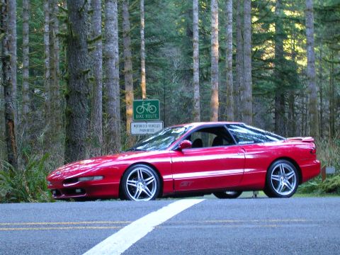1996 Ford Probe - Red 1996 Ford Probe GT parked on a road with a bike route sign in the background.