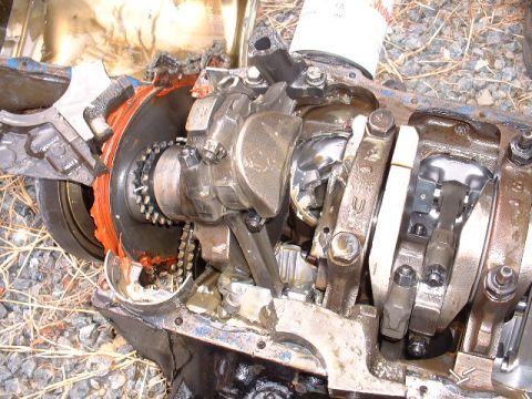 1969 Ford Mustang - Close-up view of a heavily damaged engine block, revealing the internal mechanics and broken components.