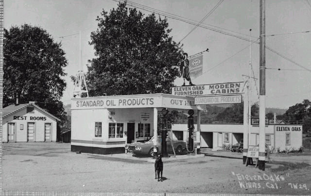 Red car parked at a Standard Oil gas station, front view