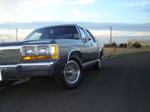 1988 Ford Crown Victoria LTD - Front quarter view of a 1988 Ford Crown Victoria LTD parked on an asphalt road.