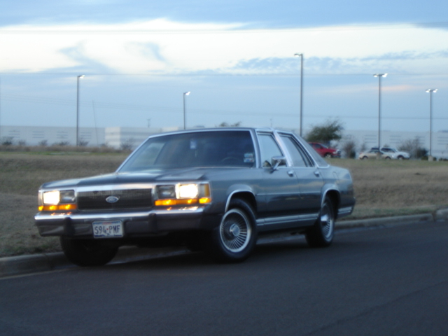 Gray 1988 Ford Crown Victoria parked on the side of the road