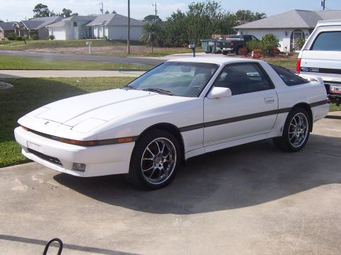 1993 Ford C-350 (Centurion Conversions) - A white Toyota Supra is parked in a suburban driveway.