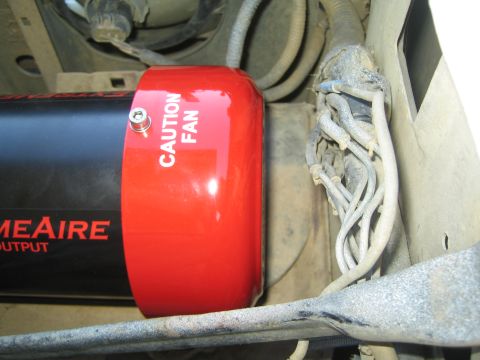 1990 Ford Bronco - Close-up of the red CAUTION FAN end cap of an ExtremeAire compressor next to a bundle of braided lines.