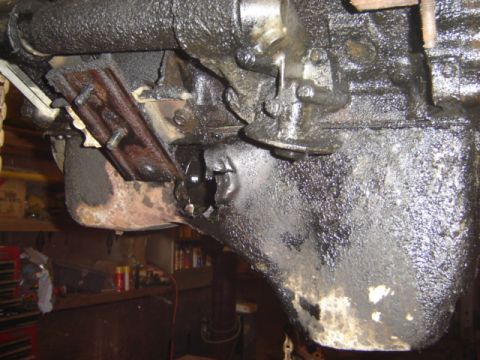 1992 Ford Bronco - Close-up view of a damaged engine block and oil pan.