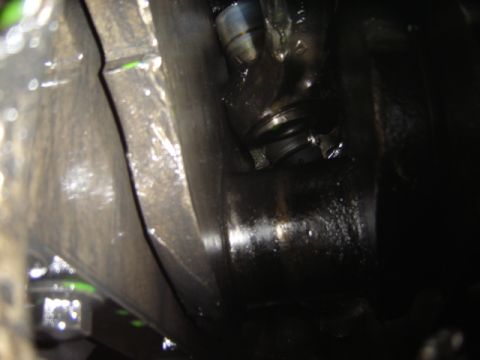 1992 Ford Bronco - A close-up view of a greasy engine part, showing signs of wear and tear.