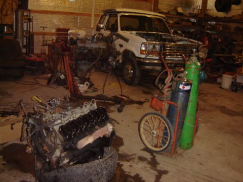 1992 Ford Bronco - Ford F-250 truck in garage with engine removed and on a stand.