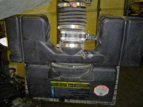 1979 Ford Bronco - This is an air intake assembly, not a 1979 Ford Bronco. It features a black plastic housing with metal clamps and a ribbed hose.