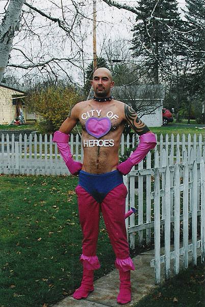1991 Ford Bronco - A man poses in a superhero costume with a heart emblem and 'City of Heroes' text on his chest.