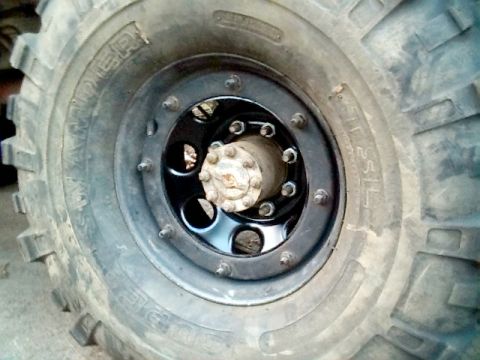 1978 Ford Bronco - A close-up view of a vehicle's wheel and tire, showing the tread pattern and rim details.