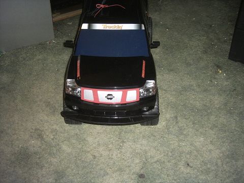1991 Ford LTD Crown Victoria - Toy truck with 'Truckin' sticker on windshield and red grille detail.