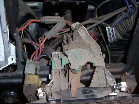 1978 Ford Bronco - This image shows a complex network of wires and mechanical parts located beneath a vehicle's dashboard.