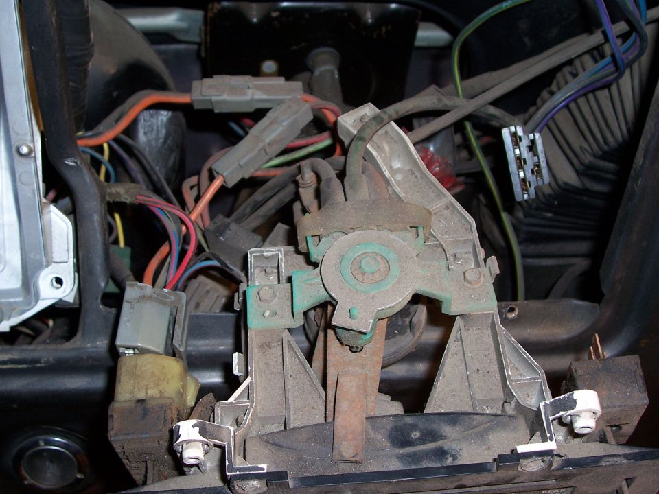 Close-up of vehicle's under-dash wiring harness and mechanical linkages