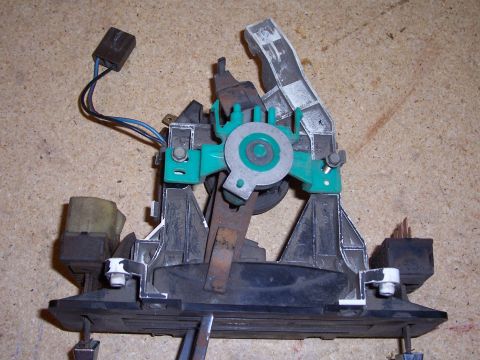 1978 Ford Bronco - Close-up of a disassembled automotive component with electrical connectors.