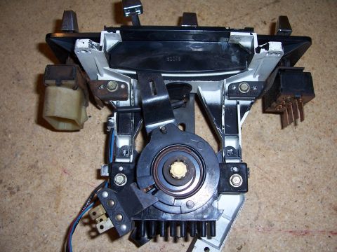 1978 Ford Bronco - This automotive part, likely from a vehicle's dashboard, is shown disassembled with visible wiring and mechanical components.