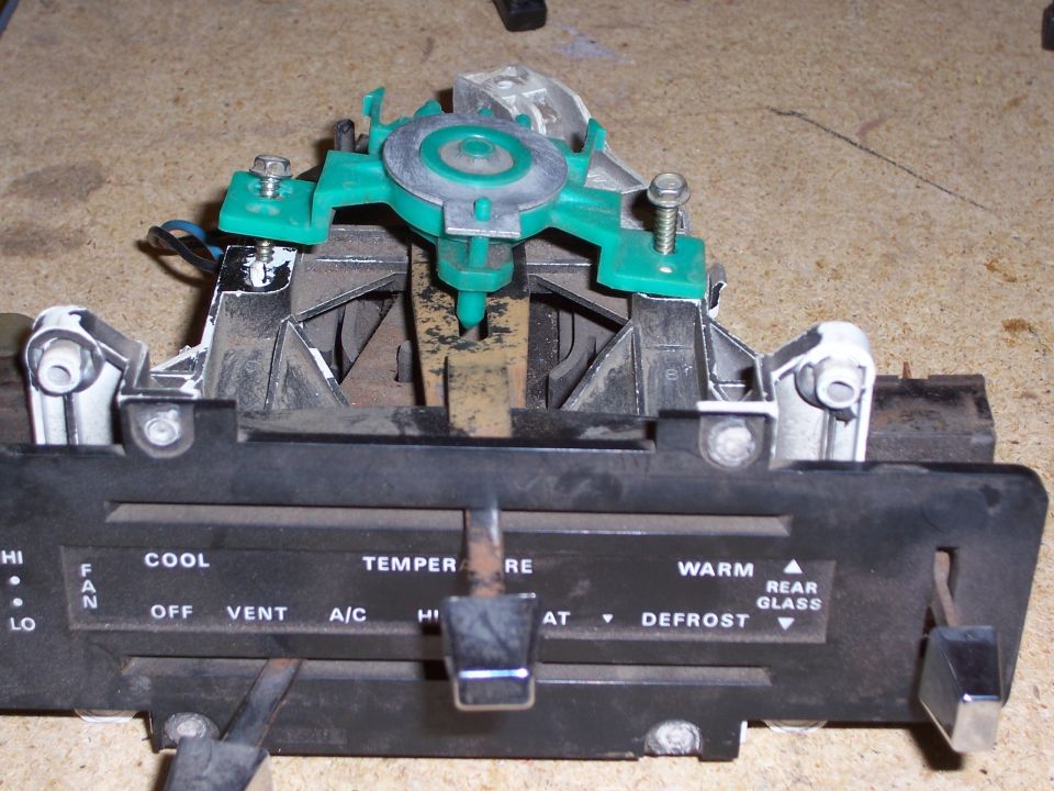 Car climate control panel with knobs for fan speed, temperature, and air direction